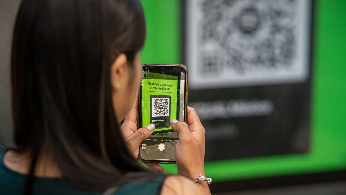 An eSIM QR code being scanned from a second screen